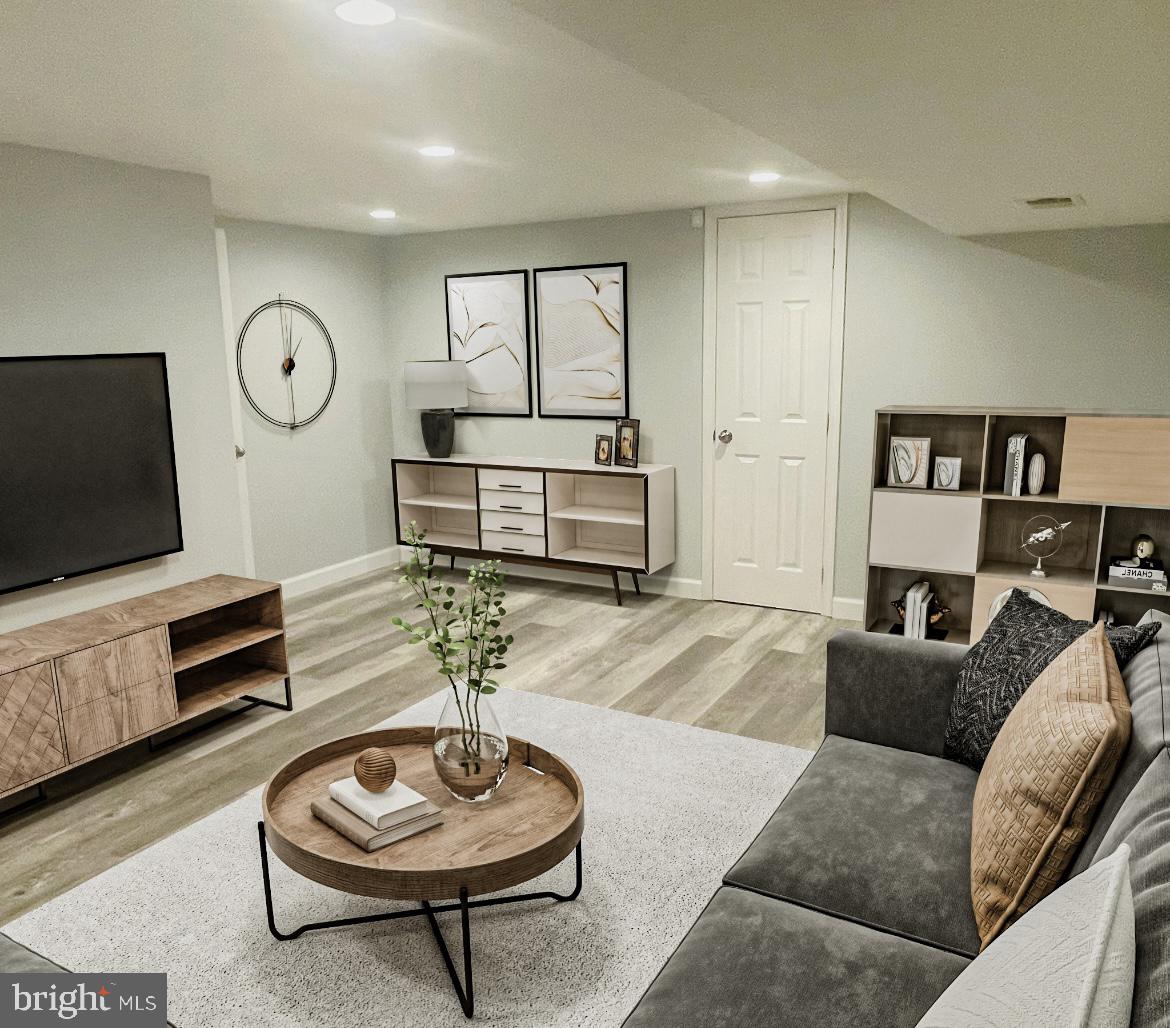 4435 Scotia Road Baltimore, MD 21227 - Photo 18 of 20 a living room with furniture a rug and a flat screen tv