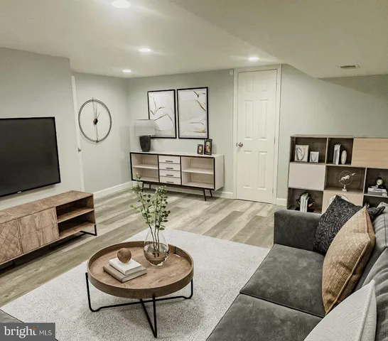 a living room with furniture a rug and a flat screen tv