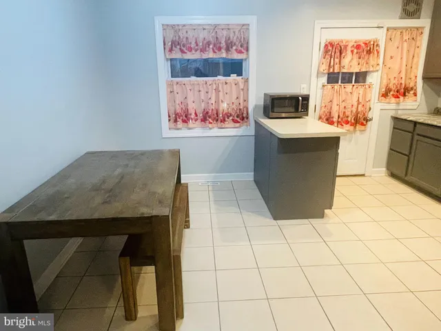 a living room with a couch and a stove top oven