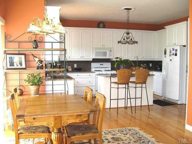 5136 Killarney Hope Drive Raleigh, NC 27613 - Photo 5 of 12 Gourmet kitchen with granite counters, tile backsplash, island, pantry, & breakfast area Kitchen