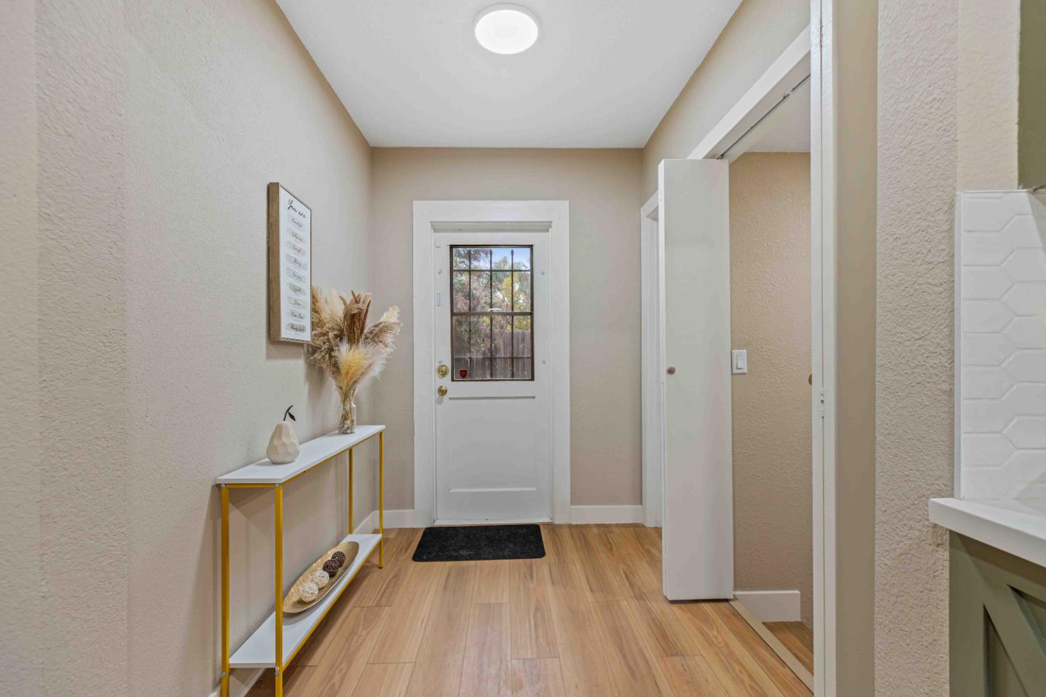 223 Achor Court Modesto, CA 95354 - Photo 13 of 26 a view of a hallway with wooden floor and a bathroom