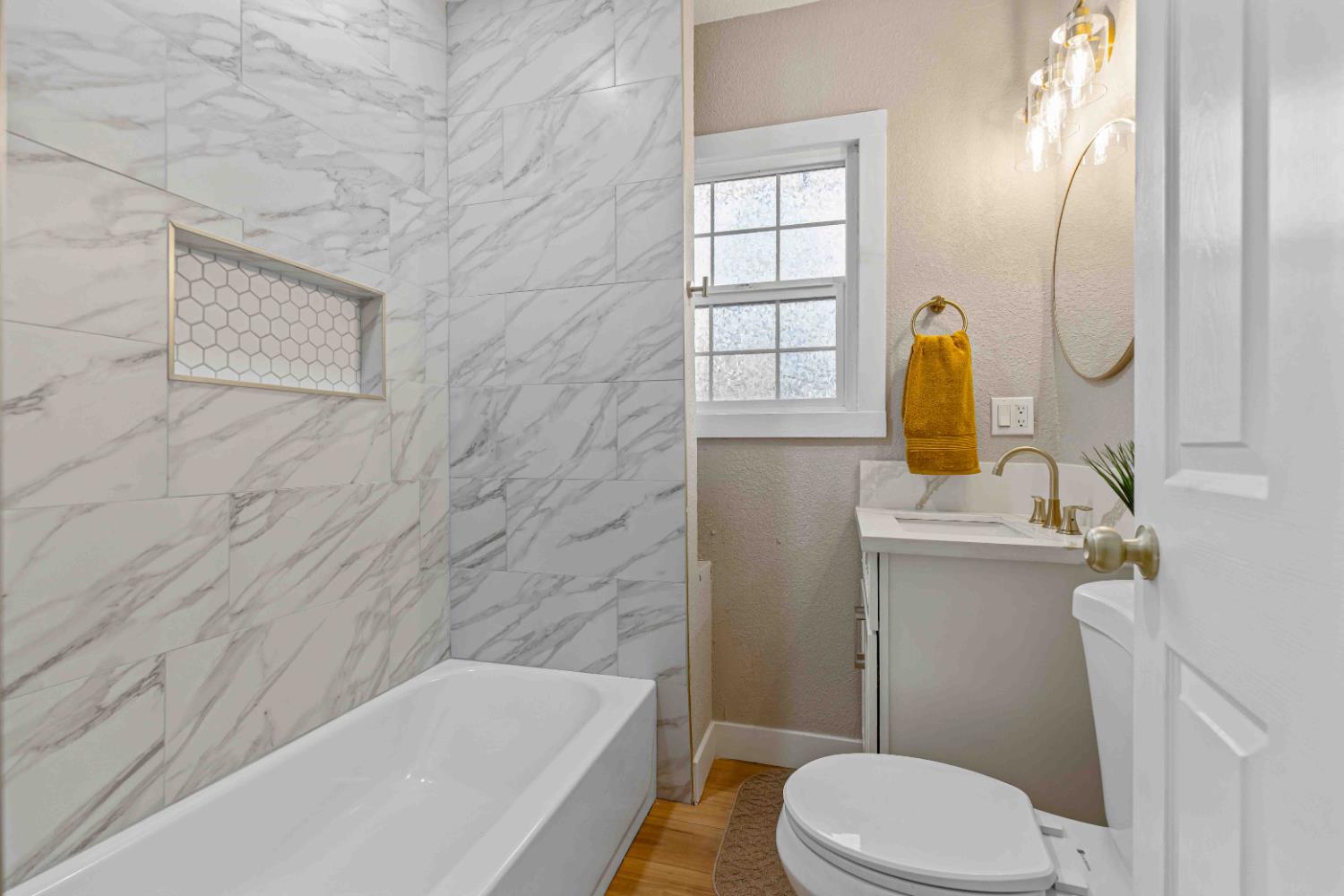 223 Achor Court Modesto, CA 95354 - Photo 9 of 26 a bathroom with a sink a toilet and shower