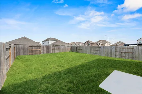a view of a green field in front of a house