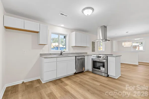 a kitchen with sink a microwave and stove