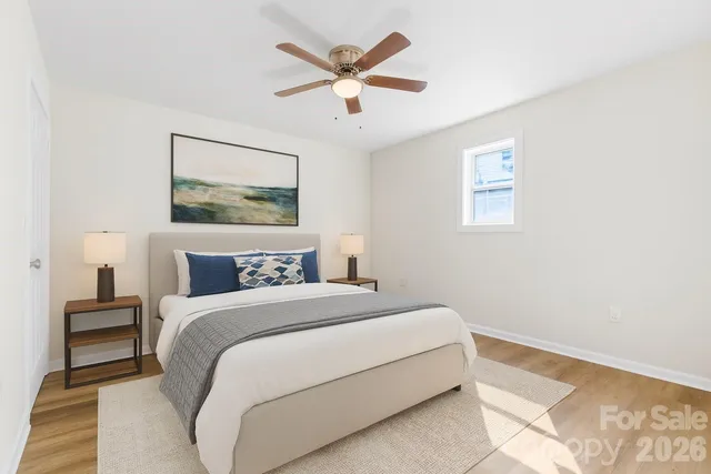 a bedroom with a bed and a painting on the wall