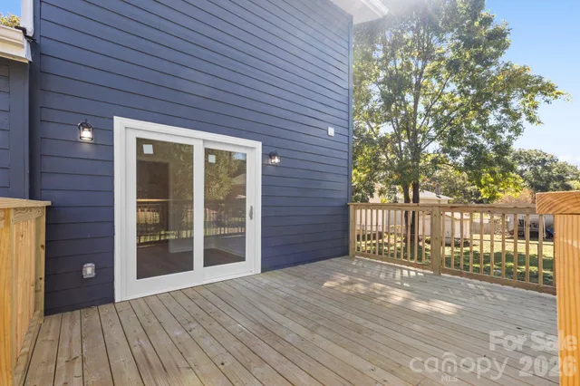 a view of backyard with a deck and wooden floor