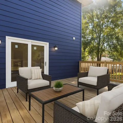 a view of a patio with couches and a dining table with garden view