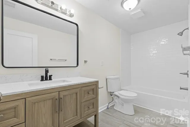 a bathroom with a sink a toilet and bathtub