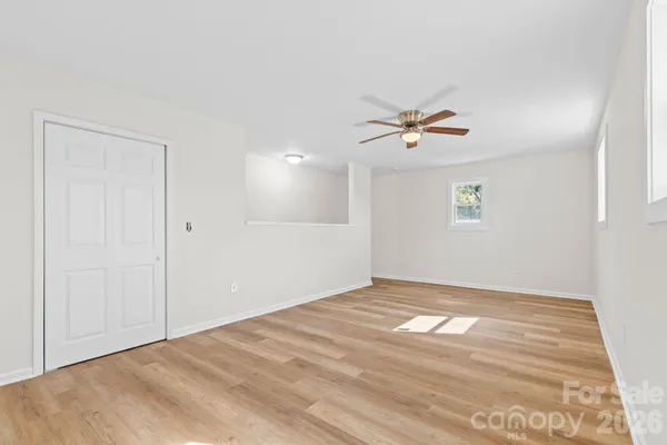 a view of an empty room with a ceiling fan
