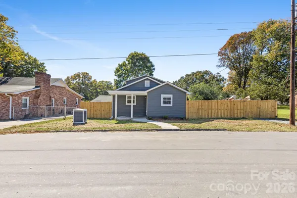 a house with a yard and a large parking space