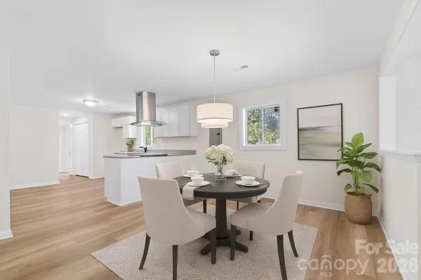 a view of a dining room with furniture and wooden floor