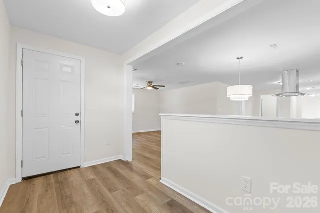 a view of a hallway to the room