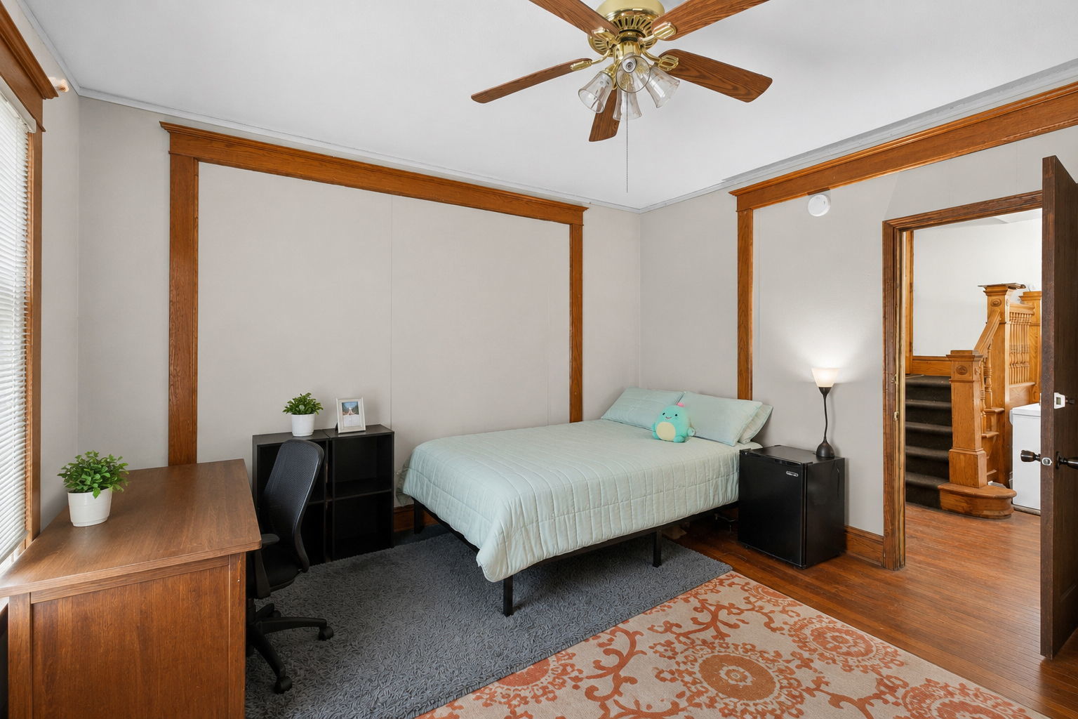 226 West Locust Street DeKalb, IL 60115 - Photo 10 of 40 a bedroom with a bed and a chandelier
