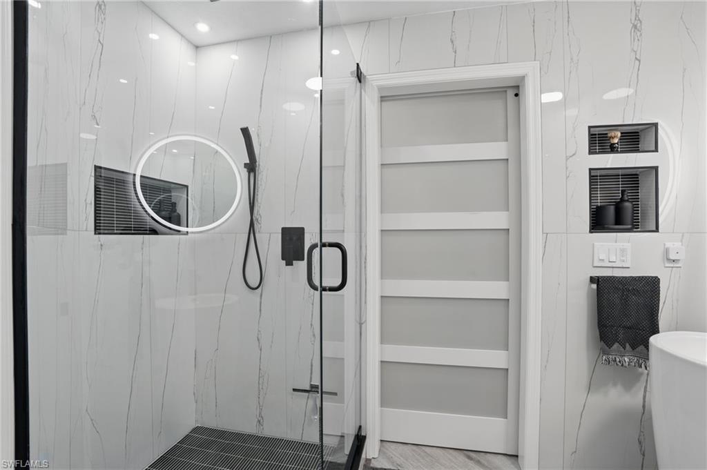 1220 Sarah Jean Circle, Unit L103 Naples, FL 34110 - Photo 23 of 50 Full bath featuring a marble finish shower