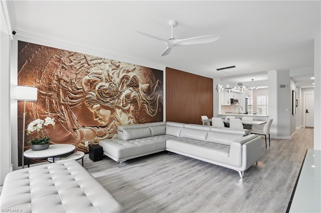 1220 Sarah Jean Circle, Unit L103 Naples, FL 34110 - Photo 4 of 50 a living room with furniture and wooden floor