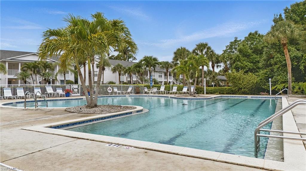 1220 Sarah Jean Circle, Unit L103 Naples, FL 34110 - Photo 41 of 50 Community pool with fence and a patio area
