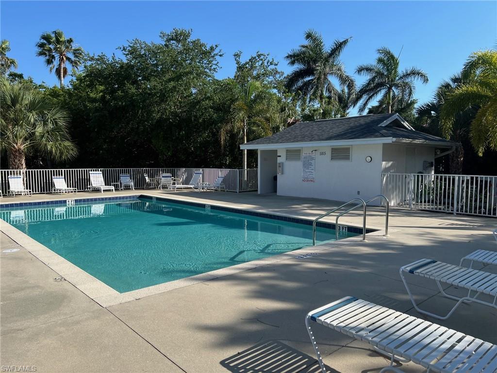 1220 Sarah Jean Circle, Unit L103 Naples, FL 34110 - Photo 47 of 50 Community pool featuring fence and a patio area