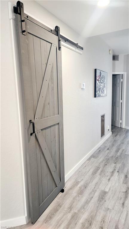 1220 Sarah Jean Circle, Unit L103 Naples, FL 34110 - Photo 5 of 50 a view of a hallway with wooden floor and staircase