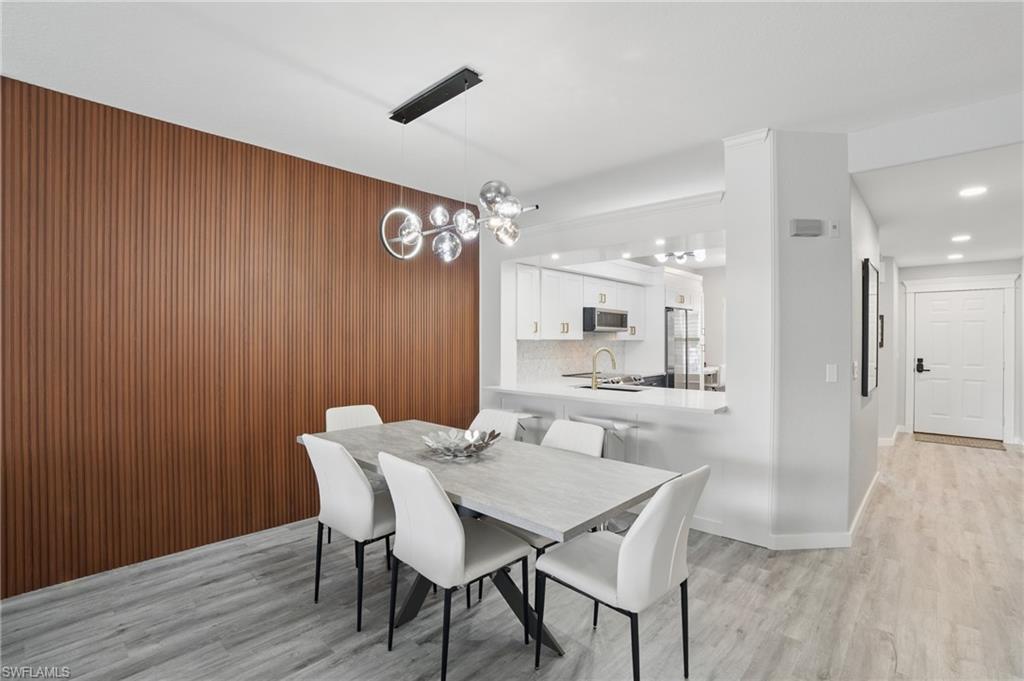 1220 Sarah Jean Circle, Unit L103 Naples, FL 34110 - Photo 8 of 50 Dining area featuring light wood-style floors, recessed lighting, a chandelier, and baseboards