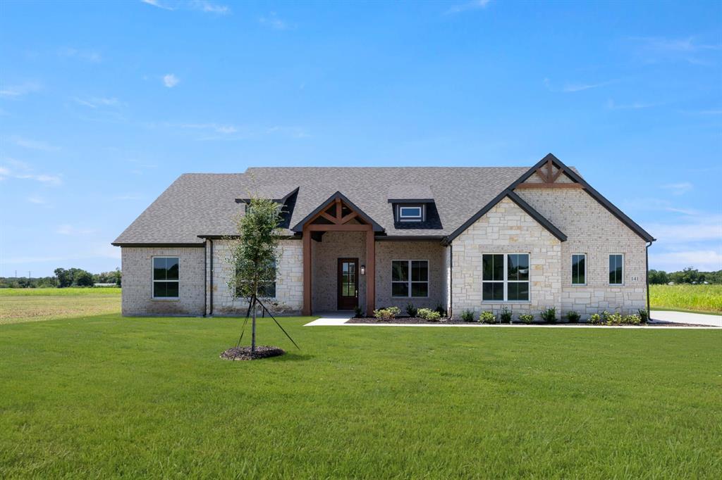 a front view of house with yard and green space