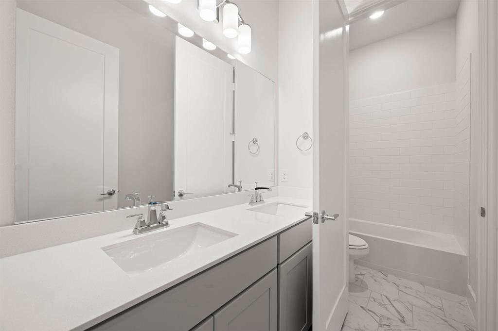 141 Olson Road Waxahachie, TX 75165 - Photo 15 of 24 a bathroom with a sink double vanity and a mirror
