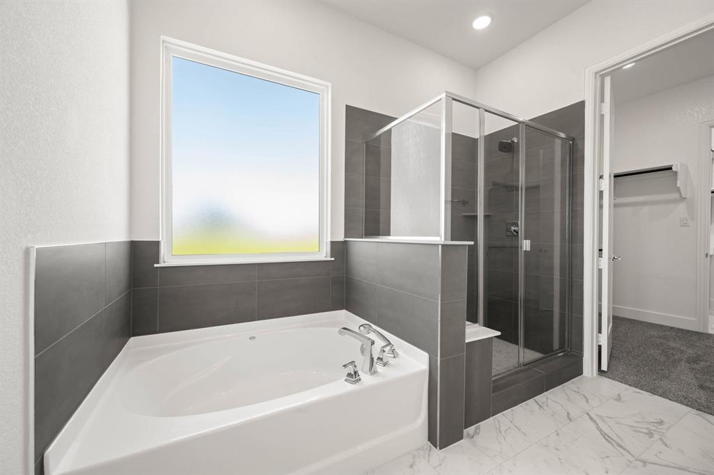 141 Olson Road Waxahachie, TX 75165 - Photo 20 of 24 a bathroom with a bathtub and a shower