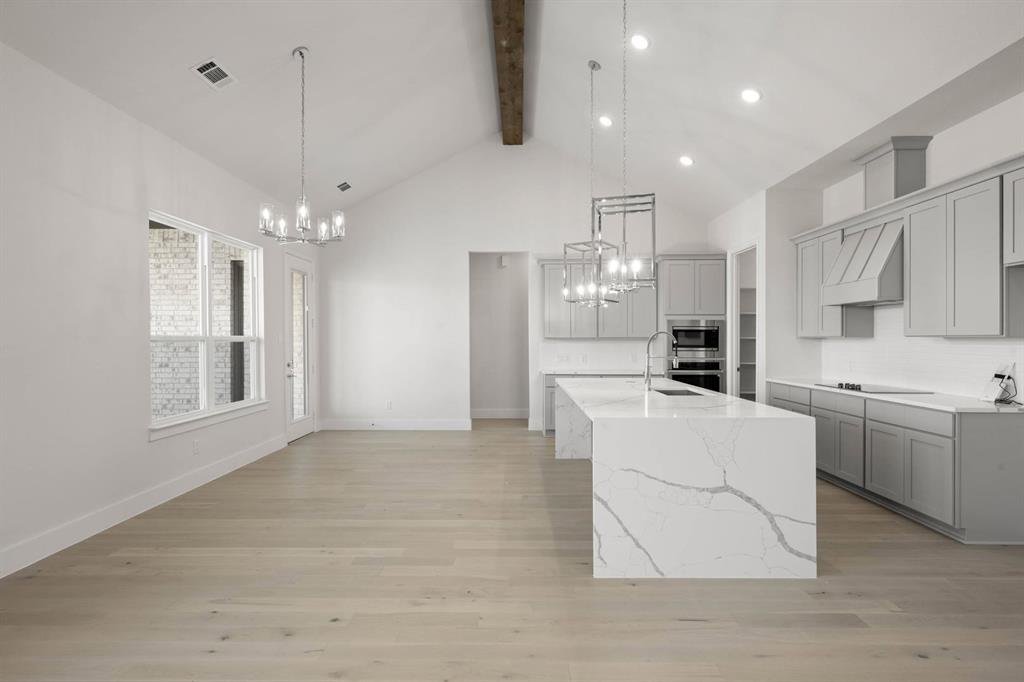 141 Olson Road Waxahachie, TX 75165 - Photo 8 of 24 a large white kitchen with cabinets a sink and a stove