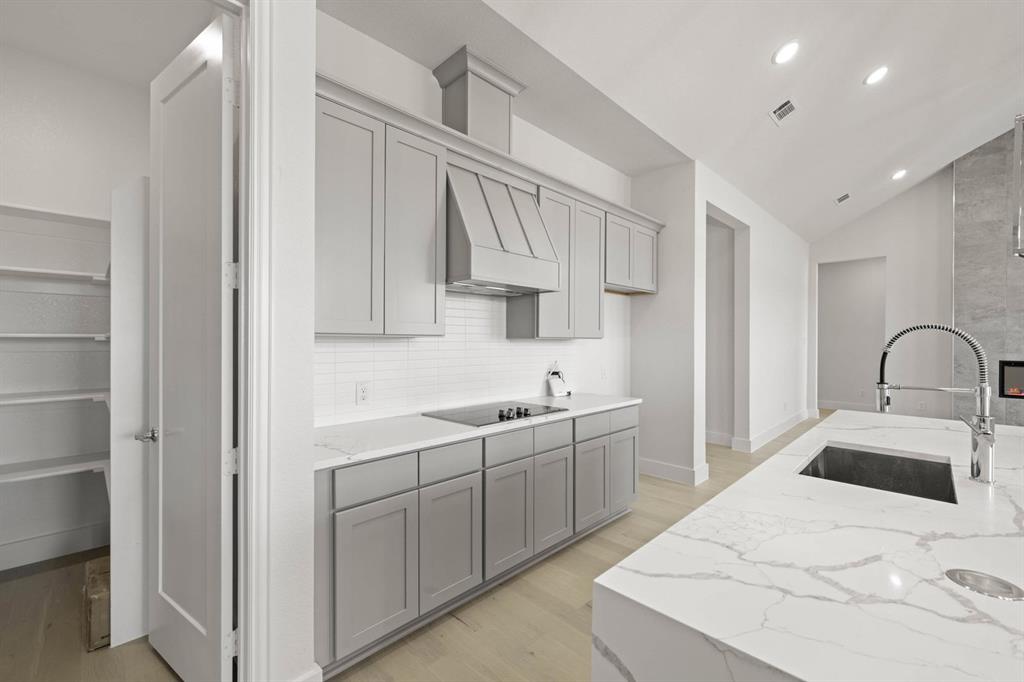 141 Olson Road Waxahachie, TX 75165 - Photo 10 of 24 a kitchen with a sink and cabinets