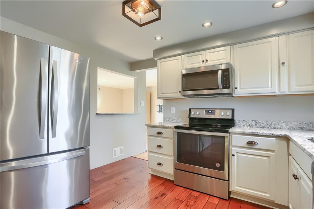 2202 Altaview Avenue Pittsburgh, PA 15226 - Photo 12 of 25 a kitchen with stainless steel appliances white cabinets and a stove top oven