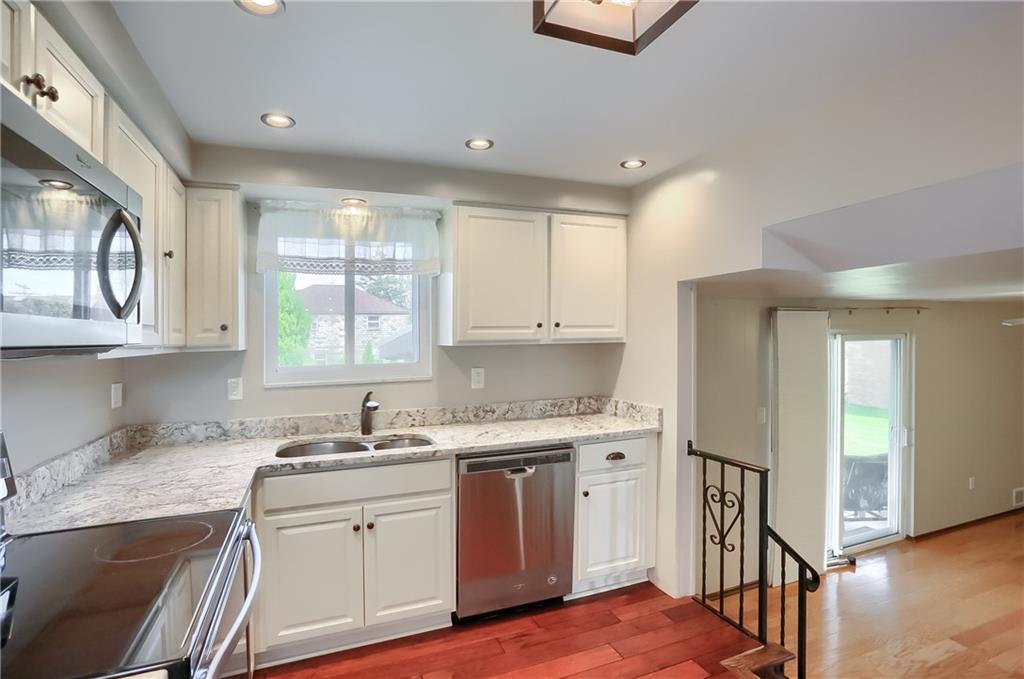 2202 Altaview Avenue Pittsburgh, PA 15226 - Photo 10 of 25 a kitchen with stainless steel appliances granite countertop a sink and cabinets with wooden floor