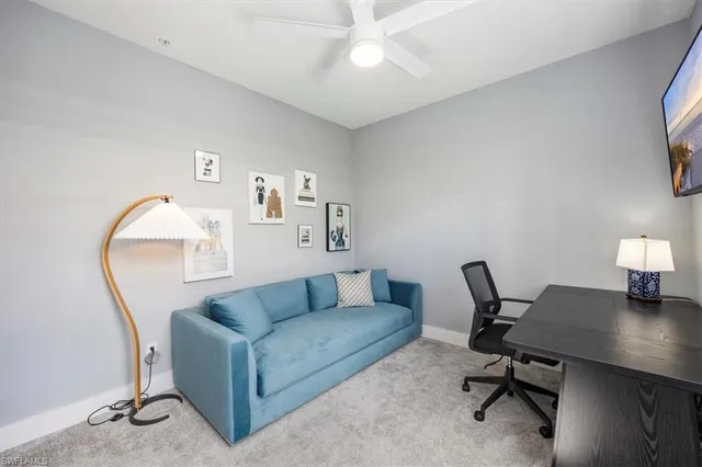 a view of a livingroom with workspace and a couch