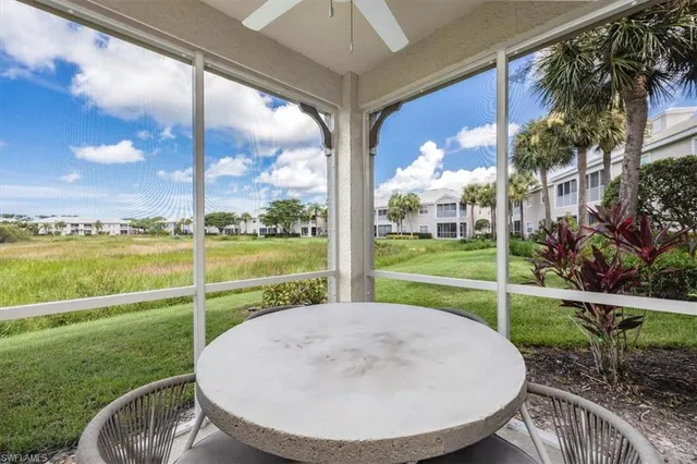 a view of a house with a backyard porch and sitting area