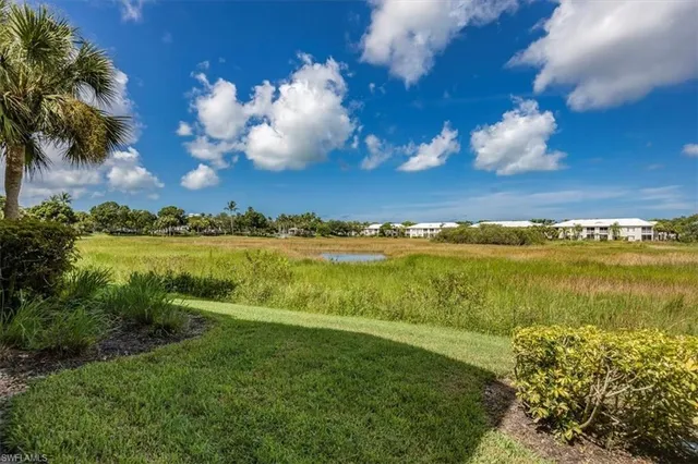 a view of a lake with houses in the back