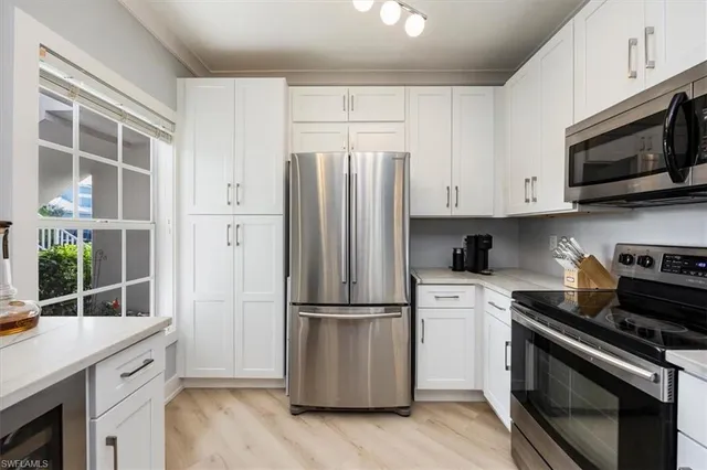 a kitchen with stainless steel appliances a stove a microwave and a refrigerator