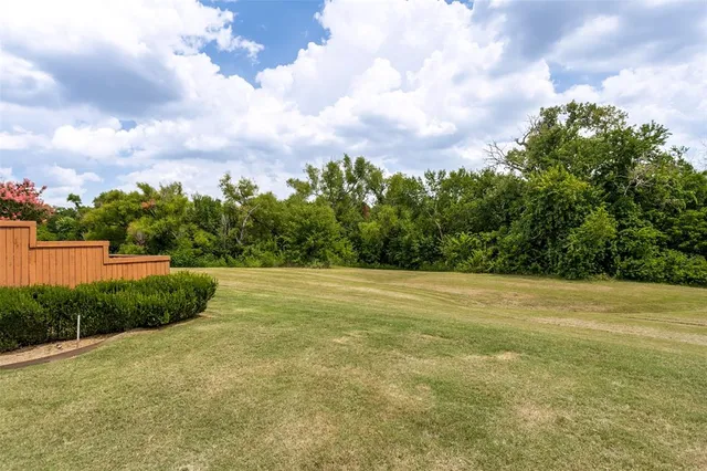 a view of a field with an trees