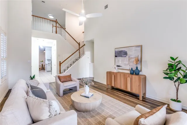 a living room with furniture and a potted plant