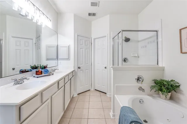 a bathroom with a tub sink and mirror