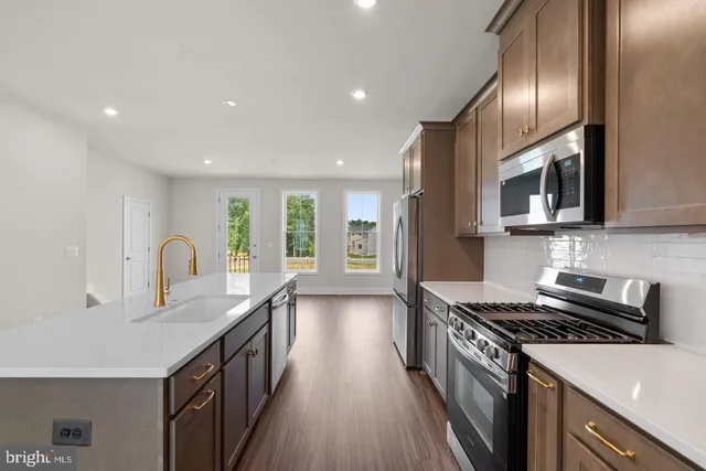 a kitchen with granite countertop a stove and a sink
