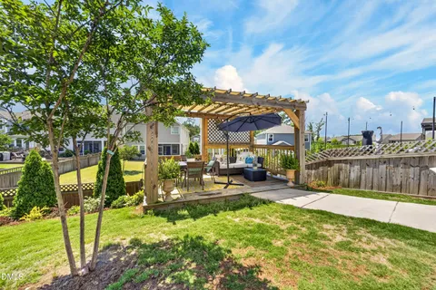 a front view of a house with a yard table and chairs