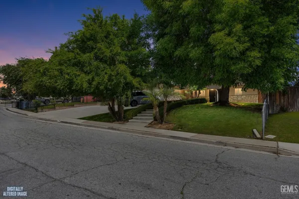 a view of street with grass and a trees