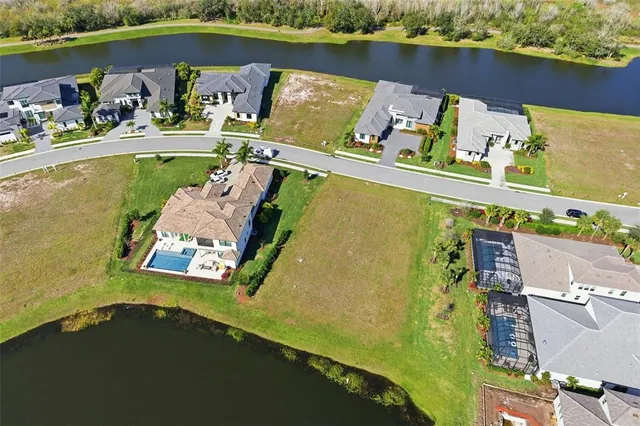 an aerial view of a house with a lake view