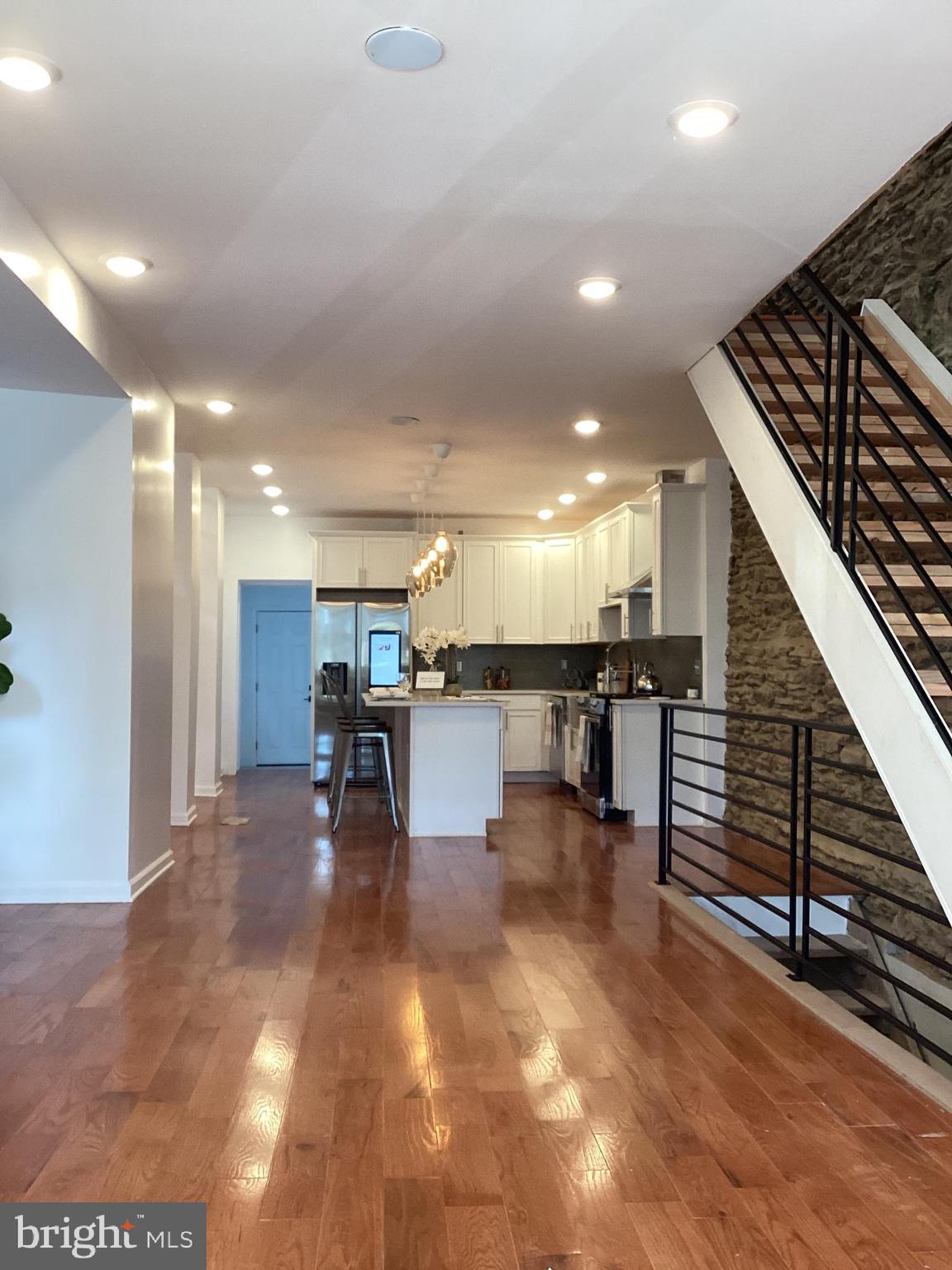 221 Slocum Street Philadelphia, PA 19119 - Photo 5 of 17 a view of kitchen with dining room and wooden floor