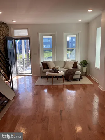 a living room with furniture window and wooden floor