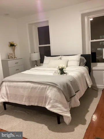 a bedroom with a bed and lamp