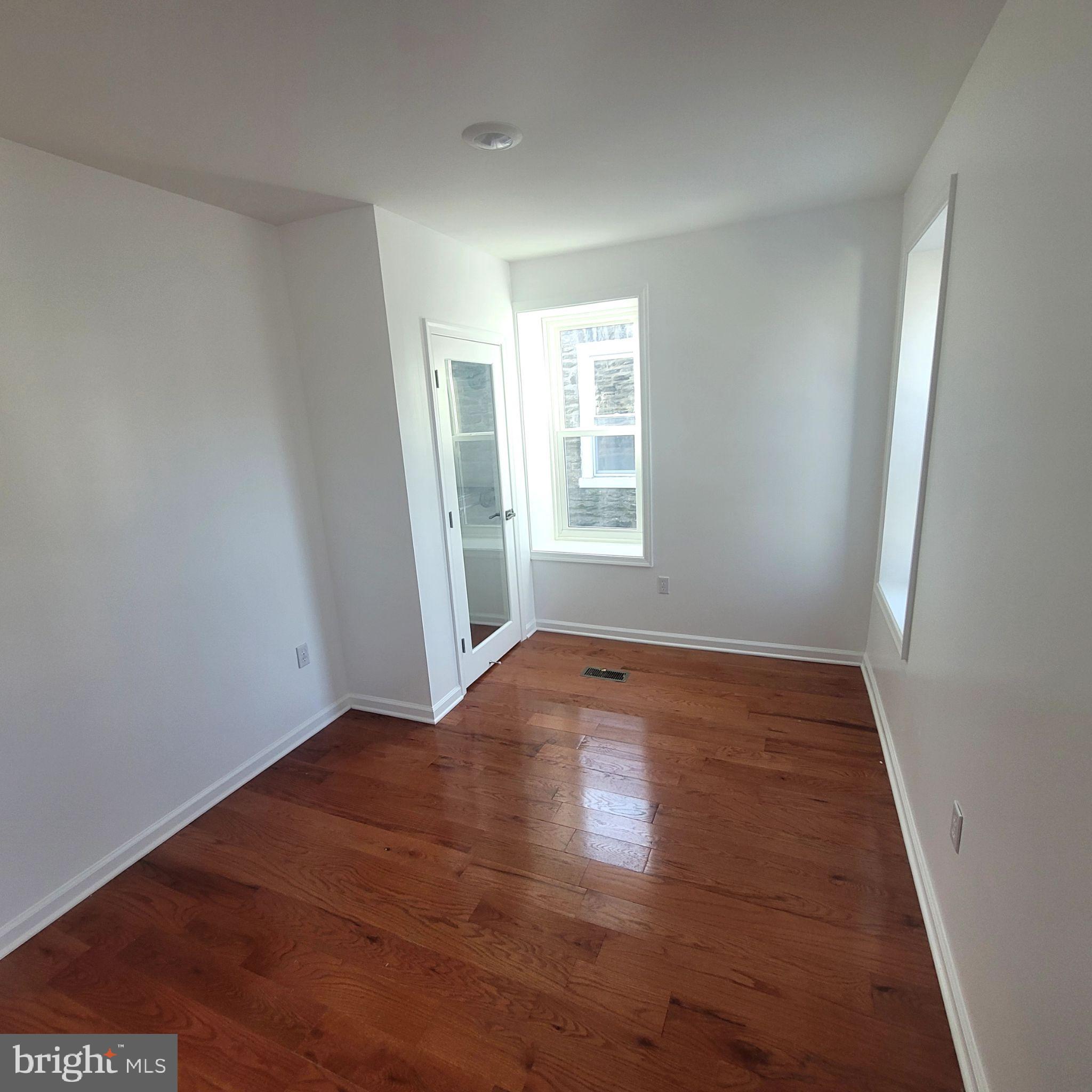 221 Slocum Street Philadelphia, PA 19119 - Photo 10 of 17 an empty room with wooden floor and windows
