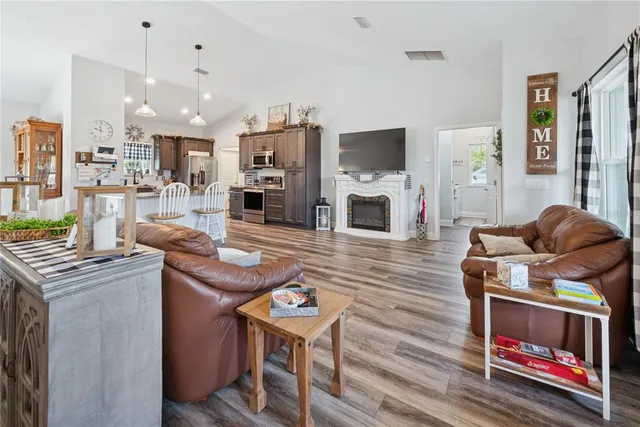 a living room with furniture a flat screen tv and a fireplace