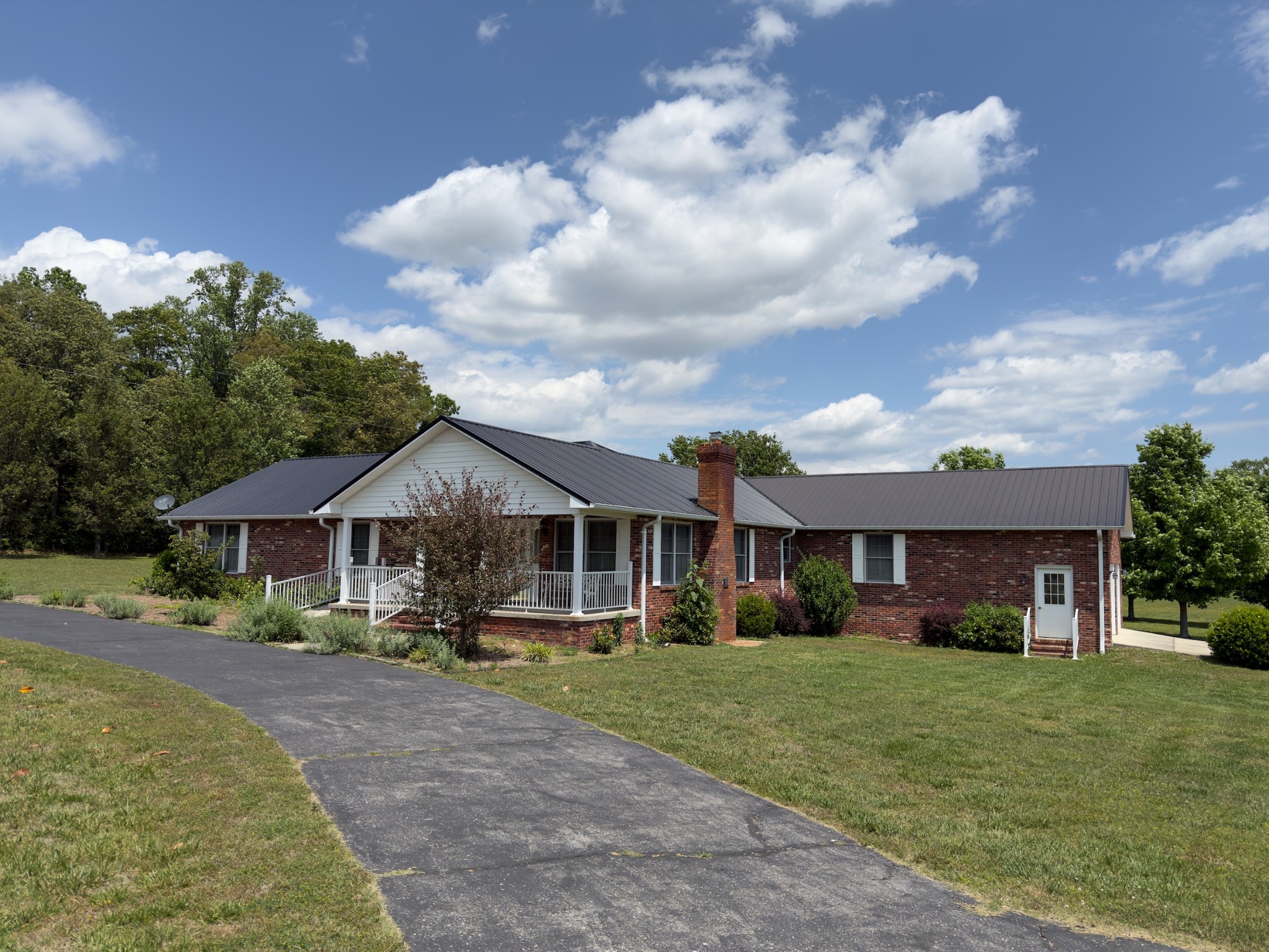 4929 Fountain Grove Road Morrison, TN 37357 - Photo 10 of 33 a front view of a house with a yard and trees