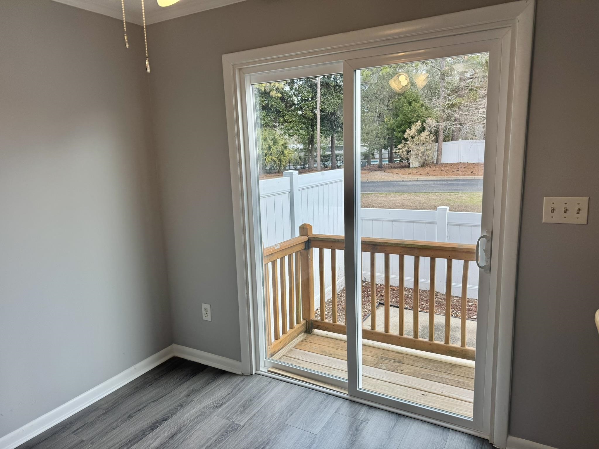 4115 Little River Road, Unit 10B Myrtle Beach, SC 29577 - Photo 14 of 31 Doorway to outside featuring baseboards and wood finished floors