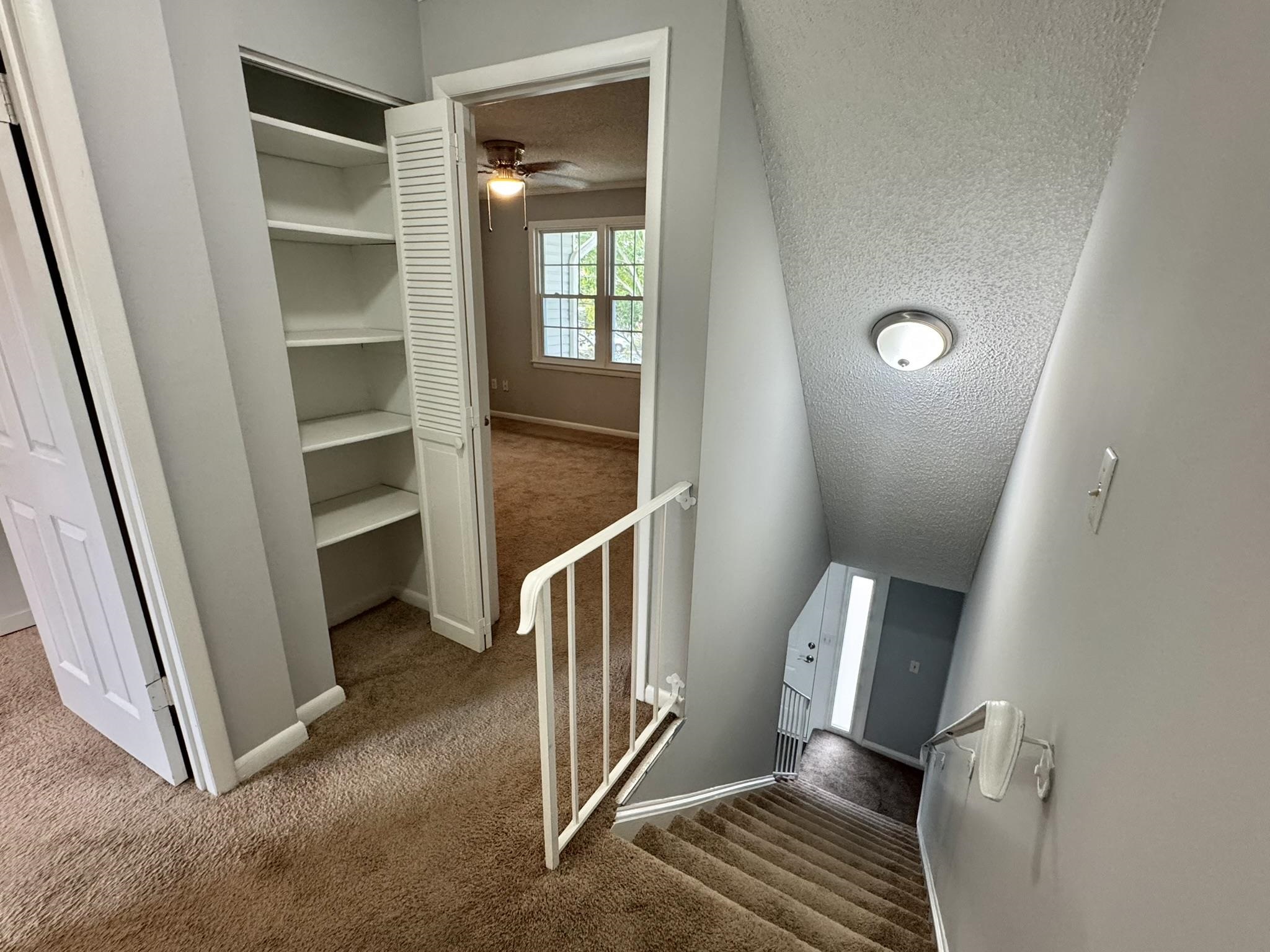 4115 Little River Road, Unit 10B Myrtle Beach, SC 29577 - Photo 20 of 31 Stairway featuring a textured ceiling and carpet floors