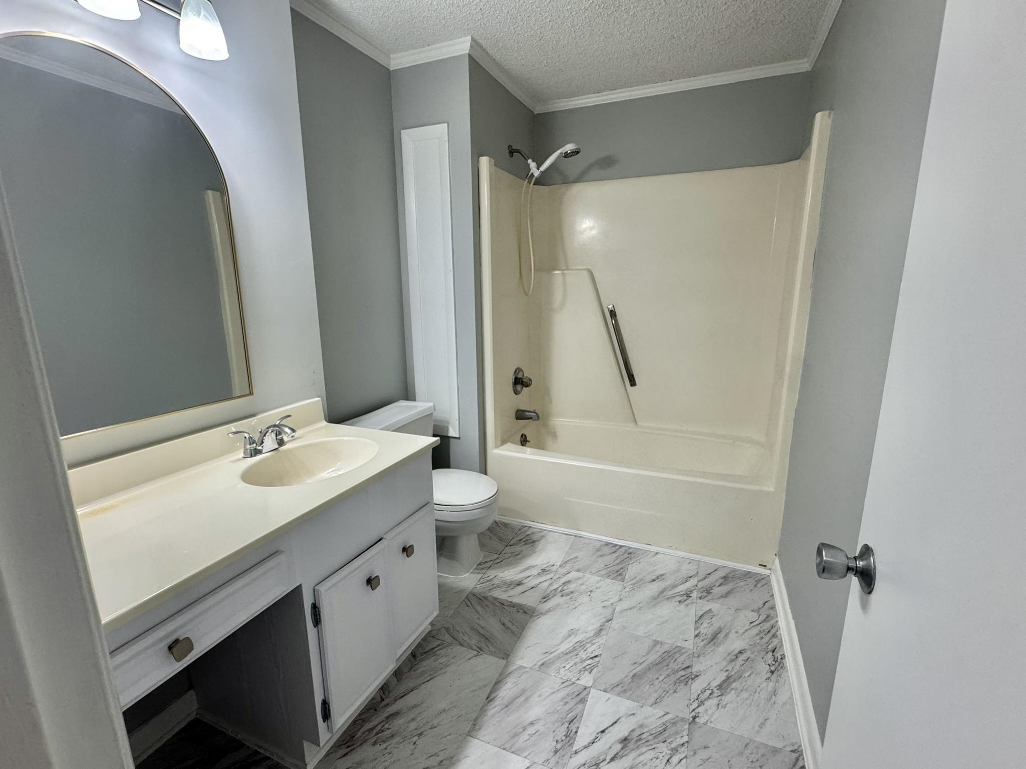 4115 Little River Road, Unit 10B Myrtle Beach, SC 29577 - Photo 25 of 31 Bathroom featuring vanity, tub / shower combination, a textured ceiling, ornamental molding, and light marble finish floors